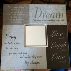 Wall plaque with decorative mirror in the center